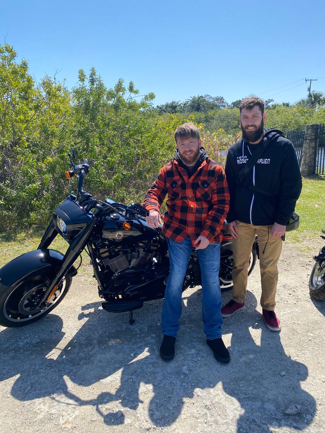 Austin and Brandon pose with Austin’s Harley-Davidson Fat Boy. 