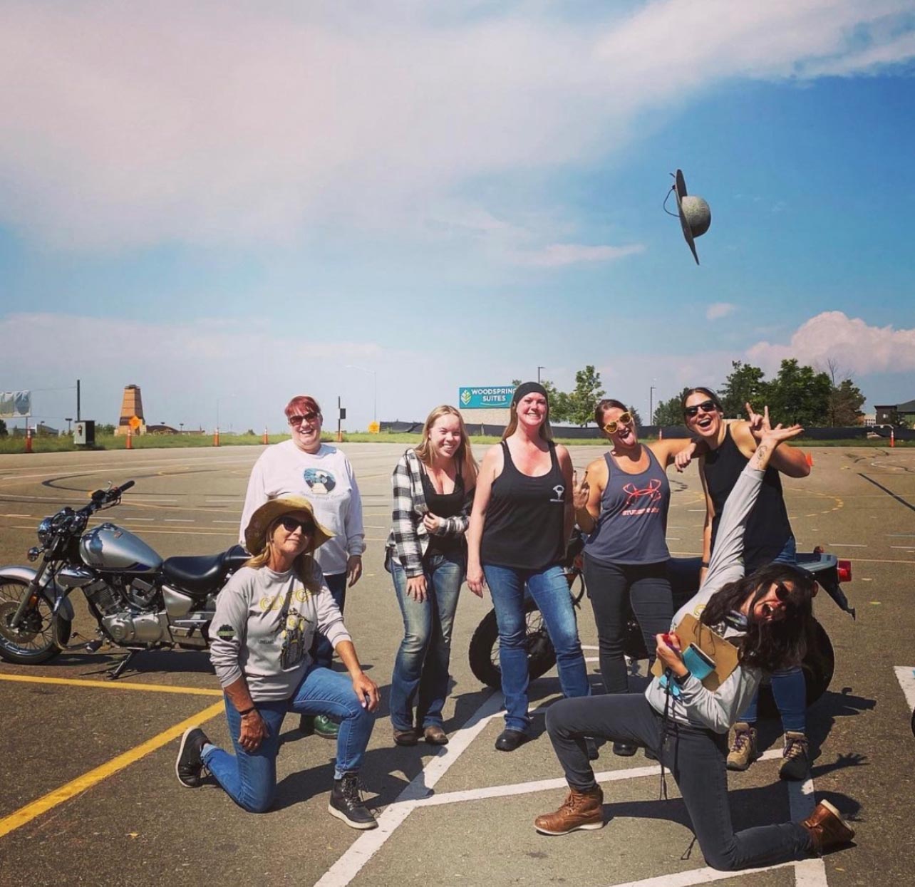 RiderCoaches Julie Gruver (left) and Armene Piper (who also goes by “Piper”) celebrate with one of Clutch Motorcycle School’s women-only classes. All the lady students, standing, passed their motorcycle endorsement test.