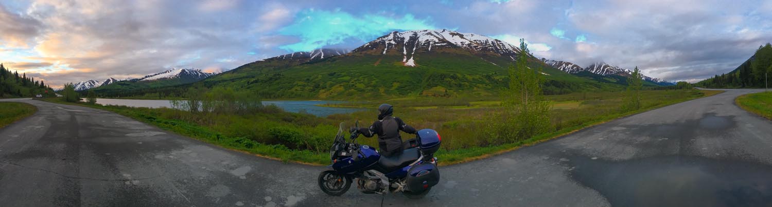 Jo and her Suzuki V-Strom in Turnagain Pass, Alaska. It was 11:30 pm on the solstice. 
