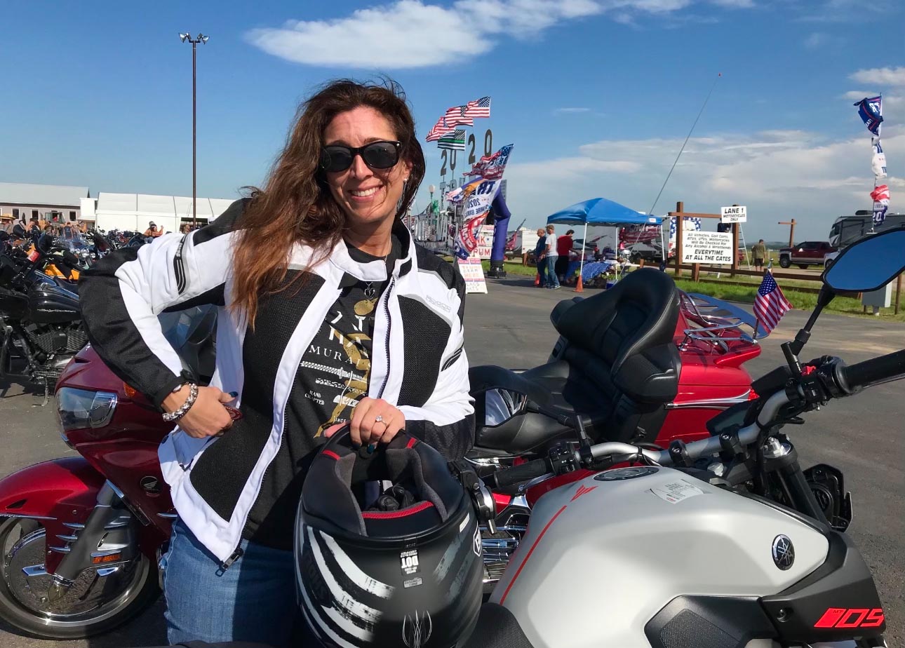 Cinnamon Kernes with her motorcycle.